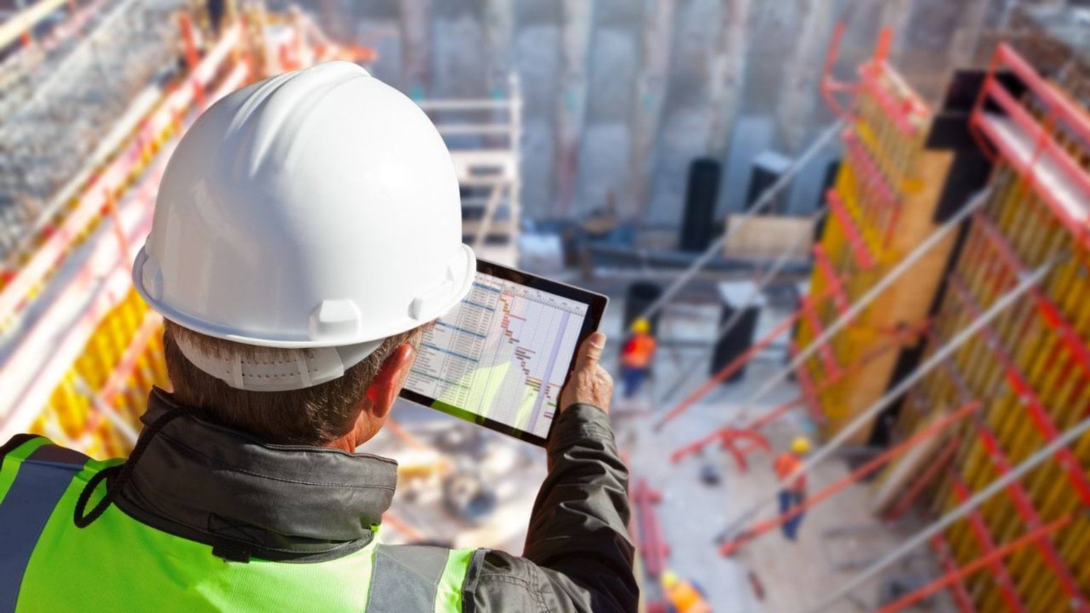 Construction worker looking over a construction site Construction worker looking over a construction site